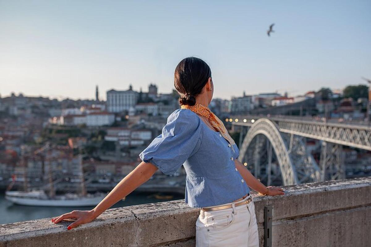 a woman standing on a ledge looking over a bridge