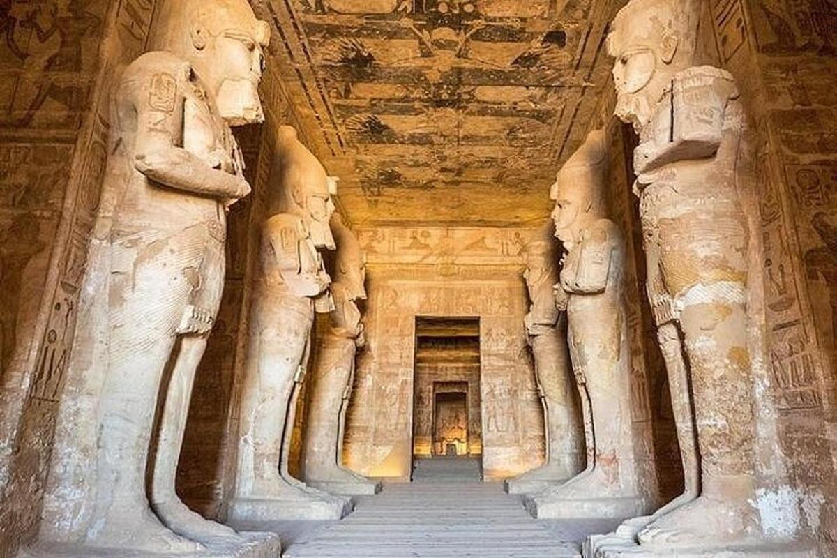 a long hallway in an ancient building with statues