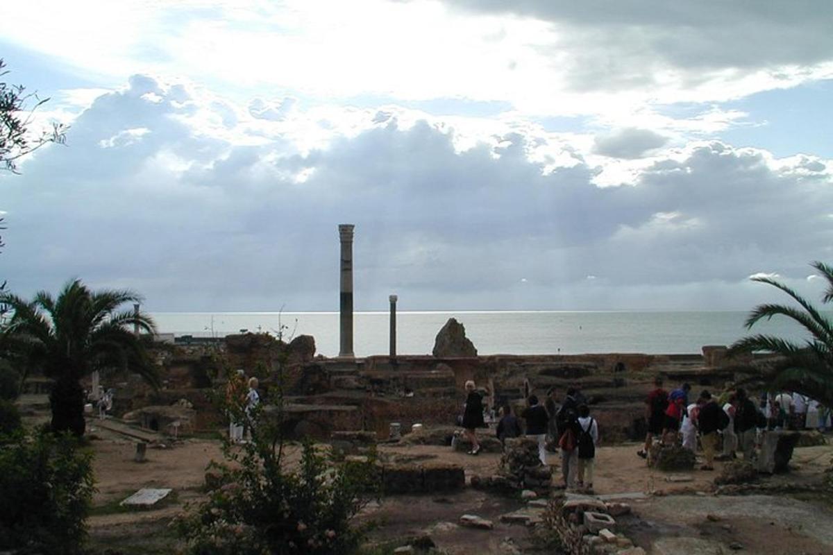 a group of people standing in front of the ocean