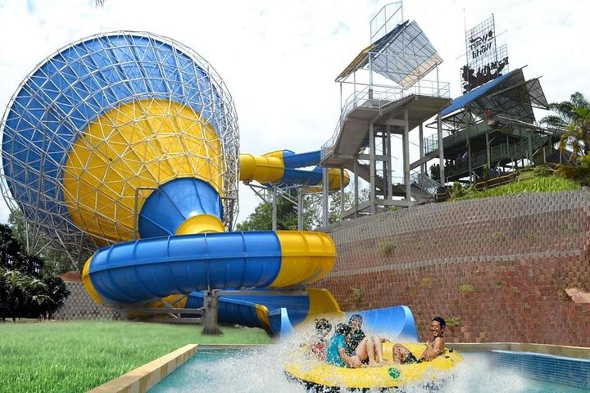 a group of people riding on a water slide at a water park