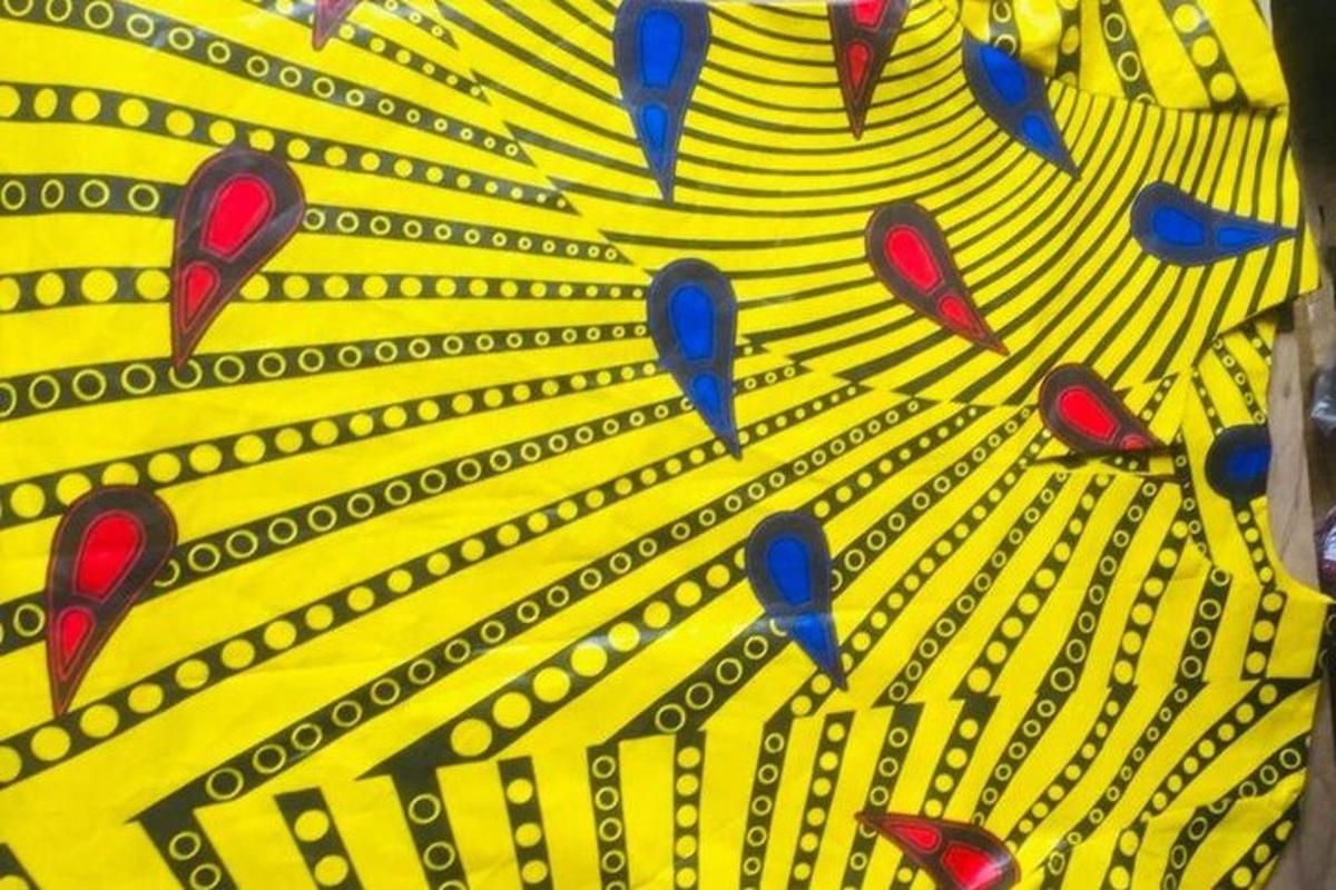 a yellow and black shirt with blue birds on it