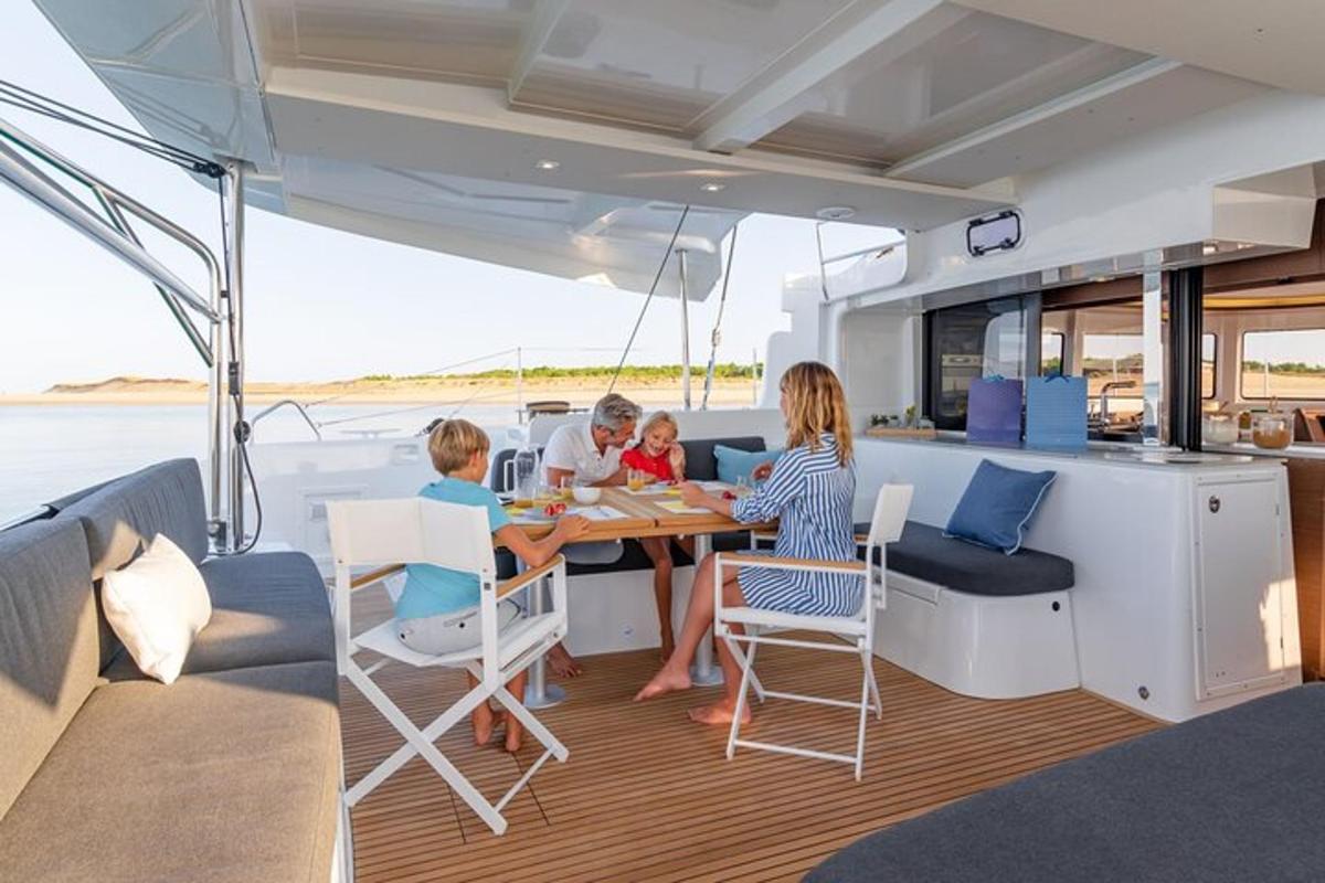 a family sitting at a table on a yacht