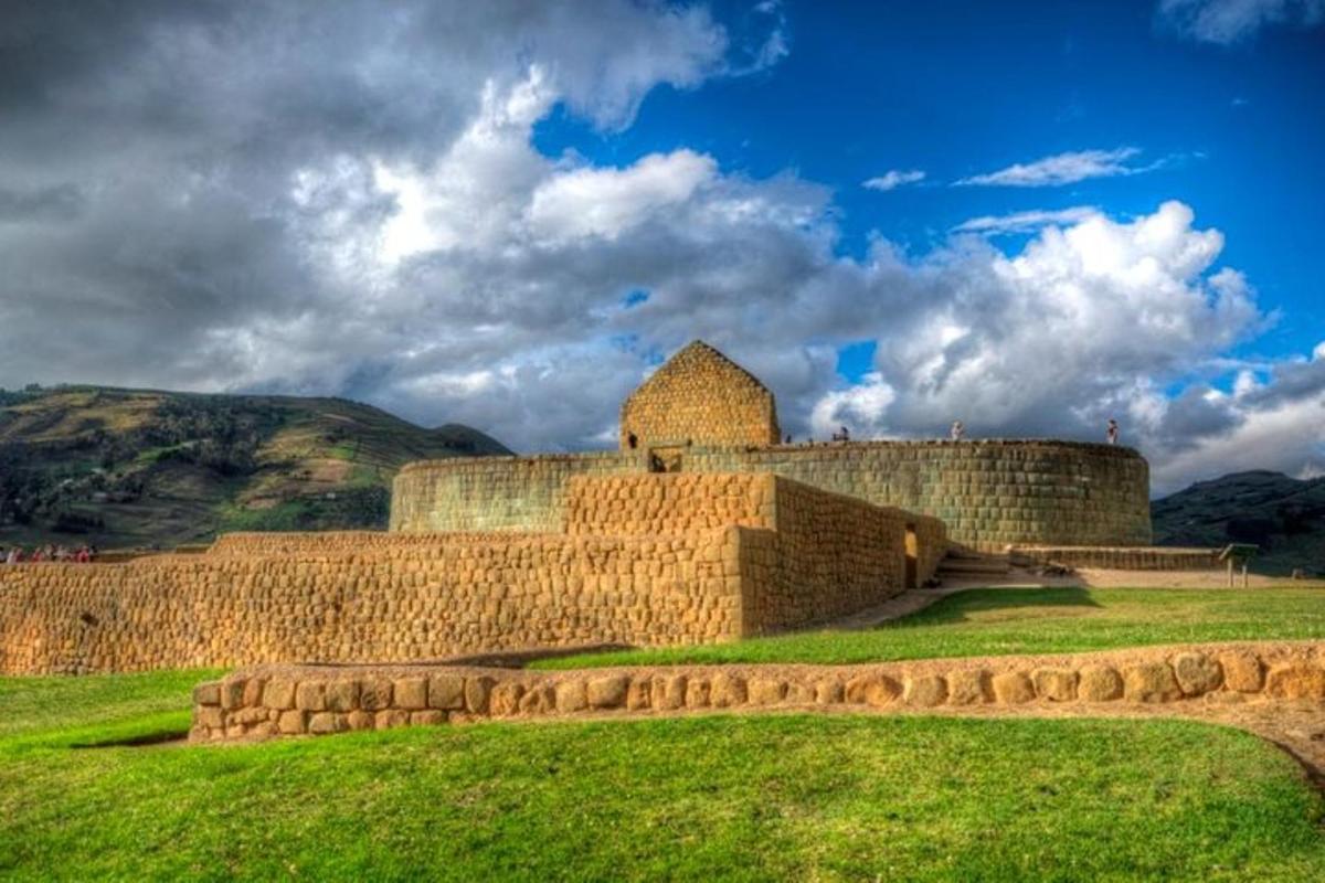 an old castle on a hill with green grass