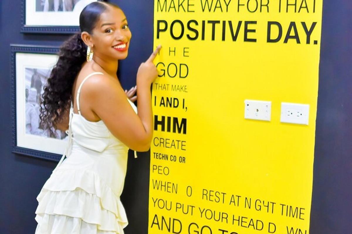 a woman in a white dress holding a sign