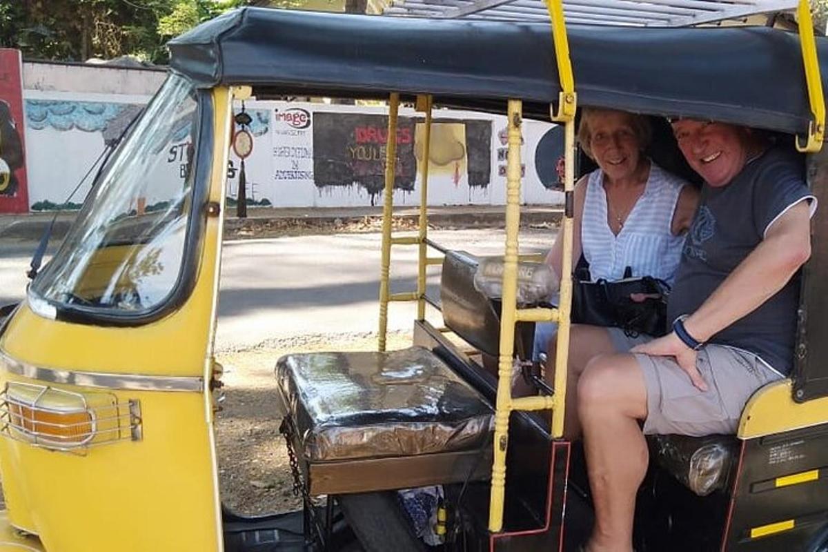 two people sitting in a yellow golf cart