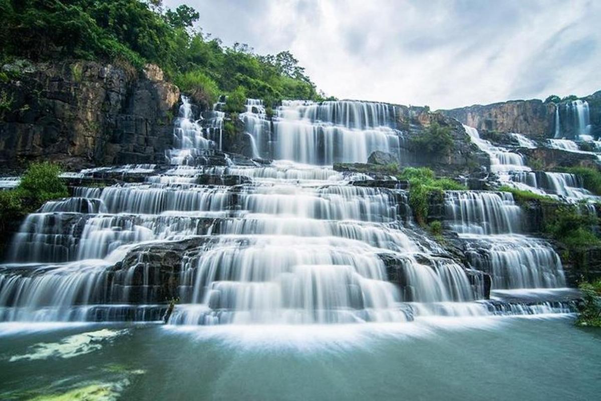 a group of waterfalls on the side of a mountain