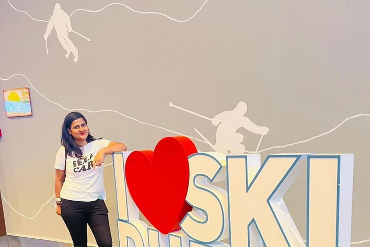 a woman standing in front of a sign with a heart