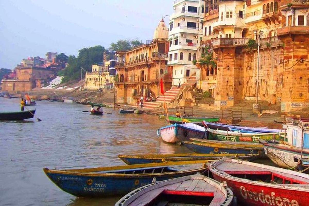 a group of boats in the water next to buildings