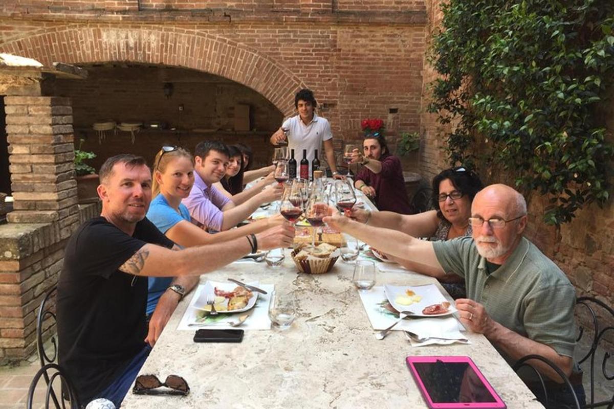 a group of people sitting around a table with wine glasses