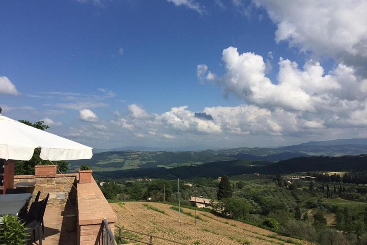 a view of the mountains from a house with an umbrella