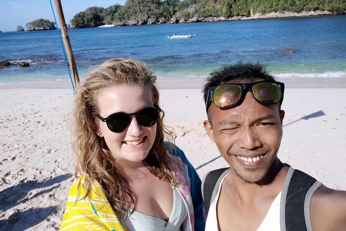 a man and a woman sitting on the beach