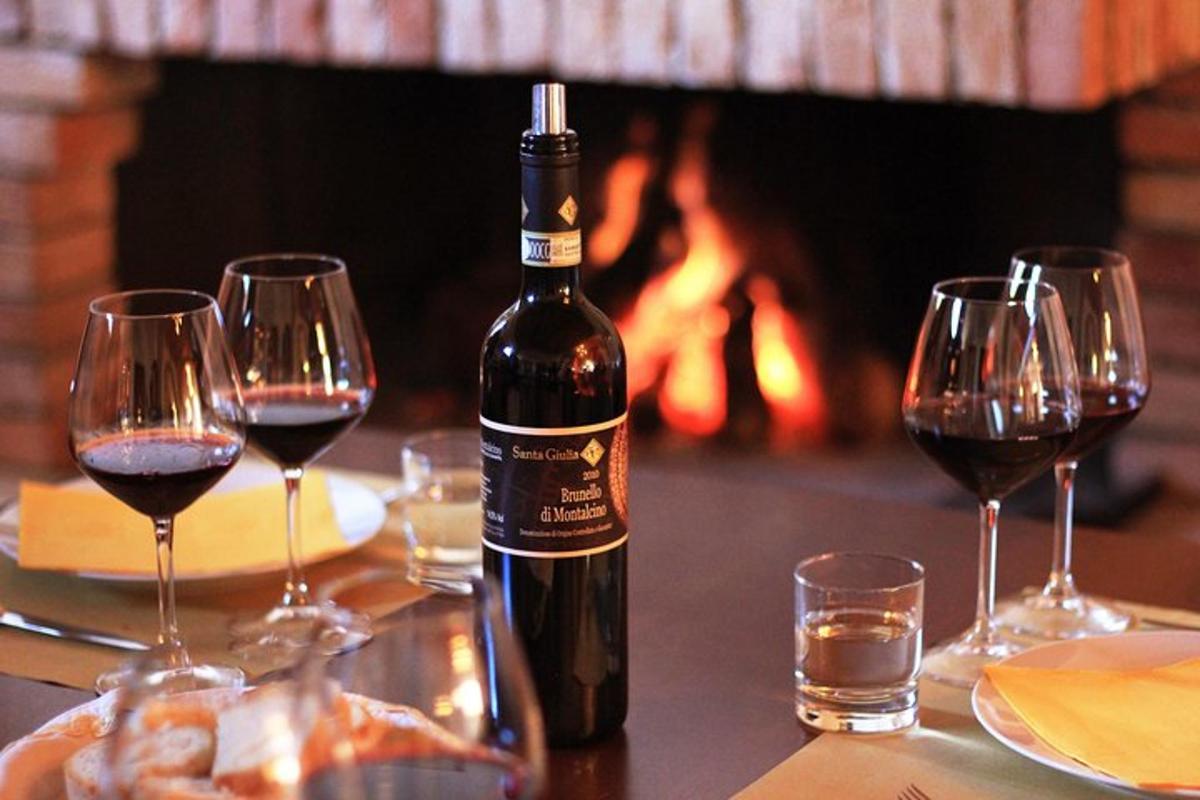 a bottle of wine sitting on a table with wine glasses