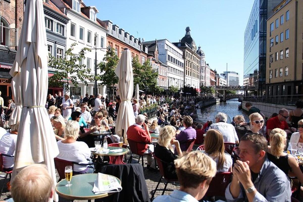 a group of people sitting at tables near a river