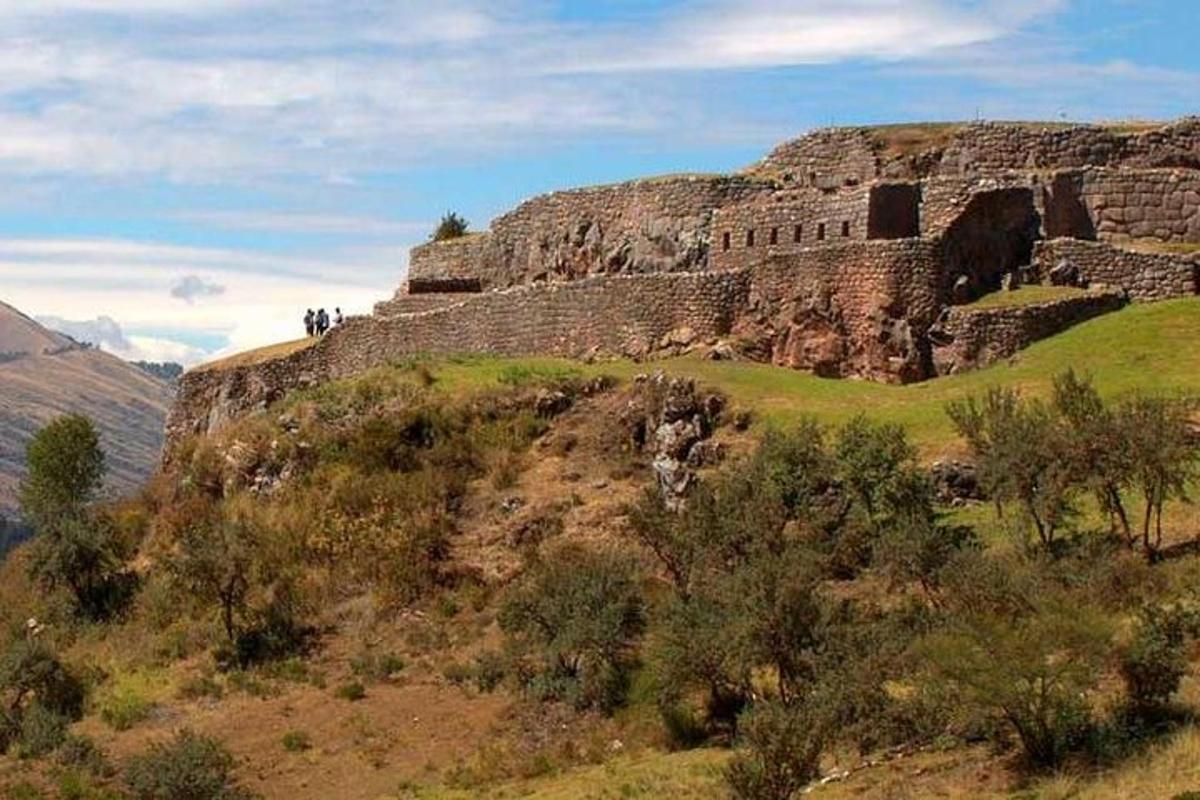 a rocky mountain with people standing on top of it