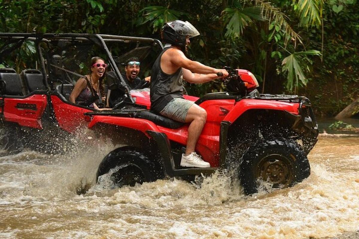 isang grupo ng mga tao na nakasakay sa isang atv sa tubig