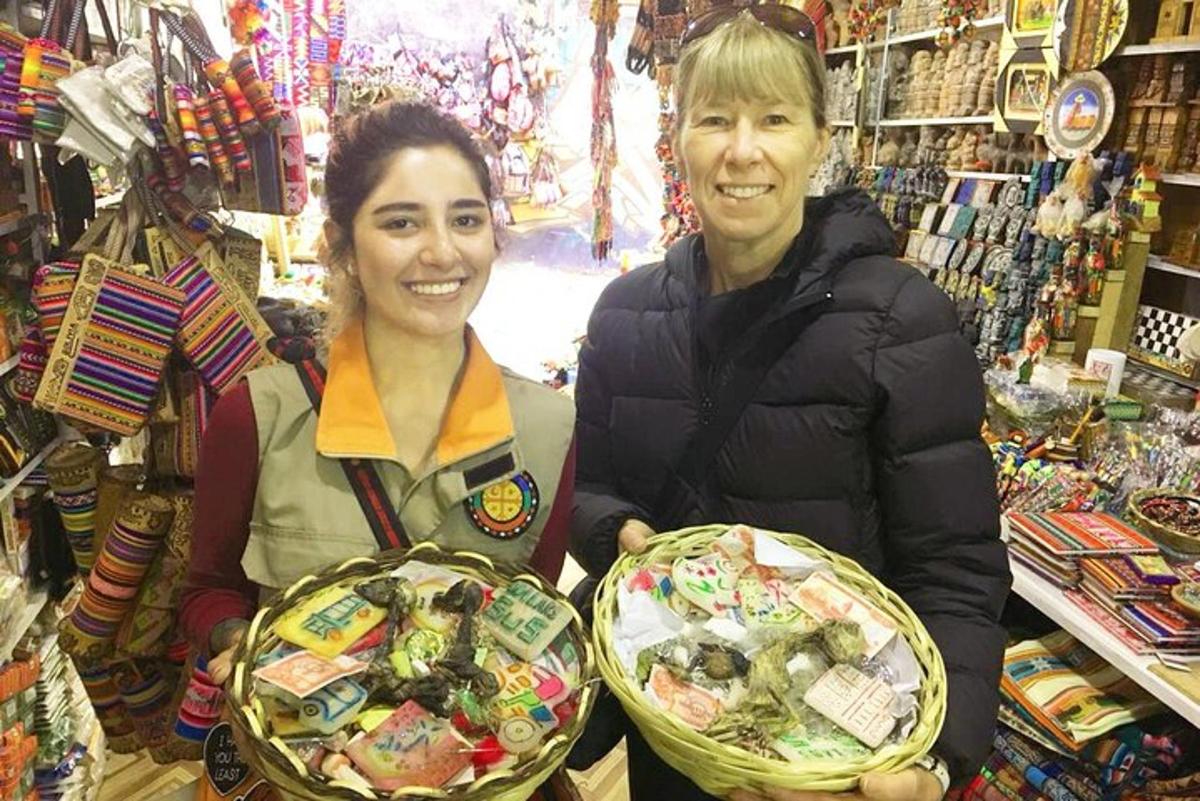 two women standing in a store holding baskets of food
