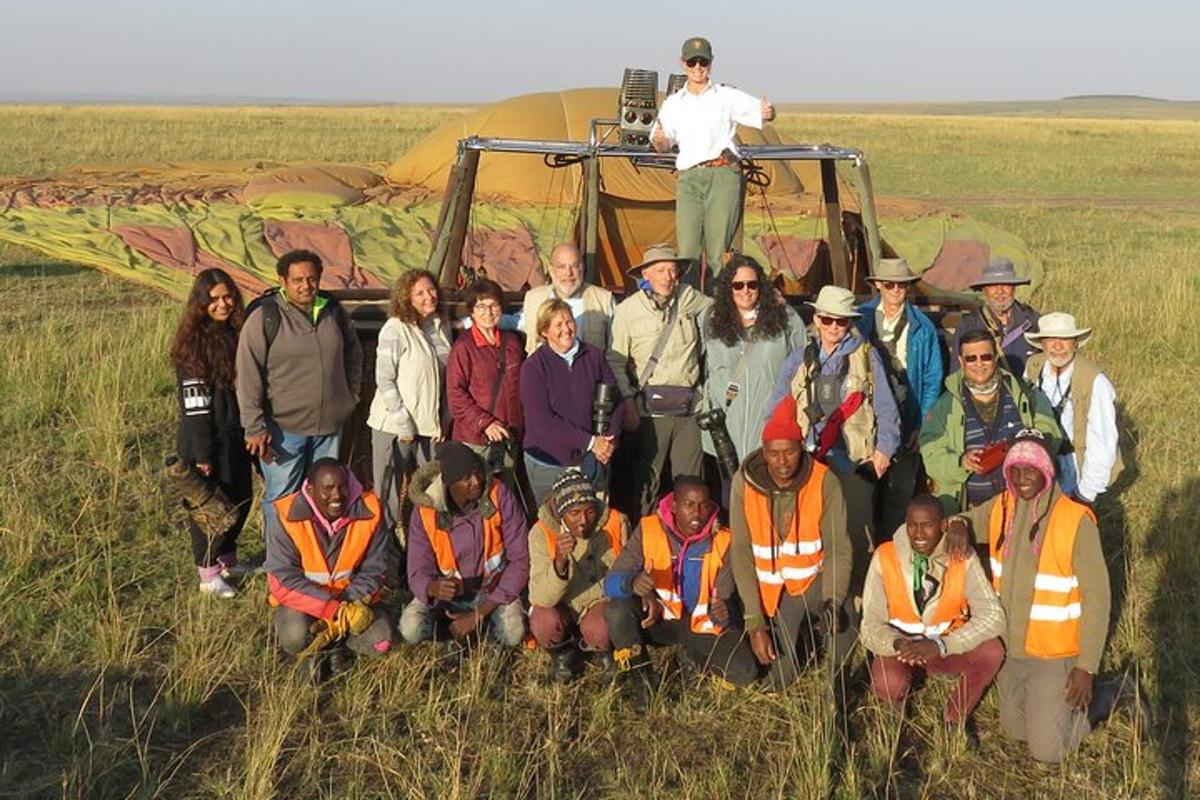 a group of people posing for a picture in front of a field