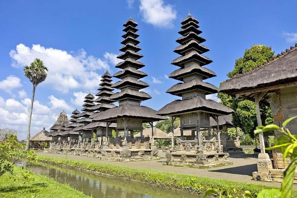 a row of pagoda buildings with chairs and a river