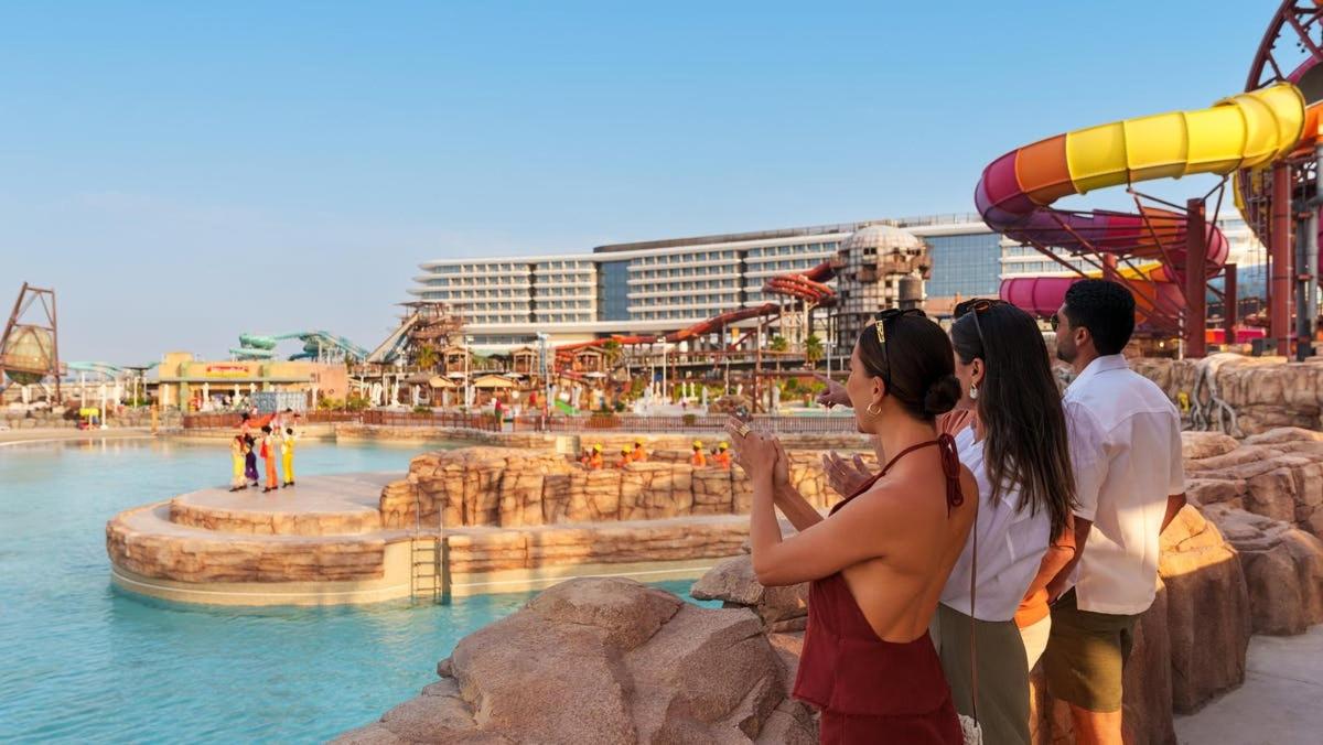 a group of people standing in a water park