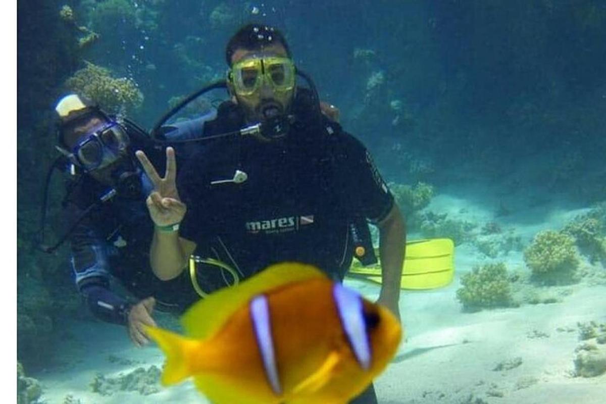Un par de personas en el agua con un pez.
