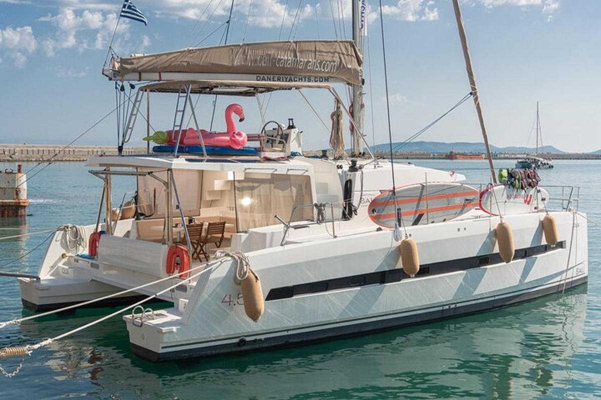 bel čoln z rožnatim flamingom na vodi