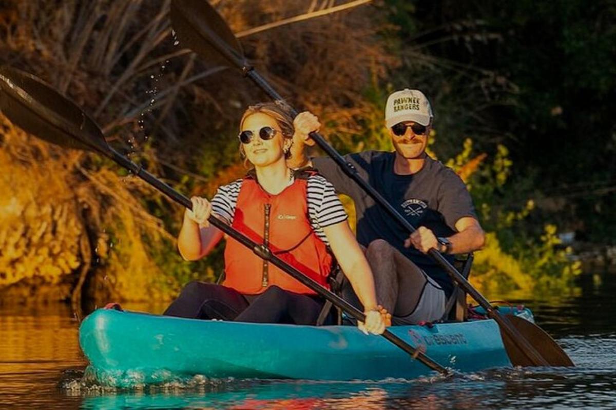 a man and a woman in a kayak on the water