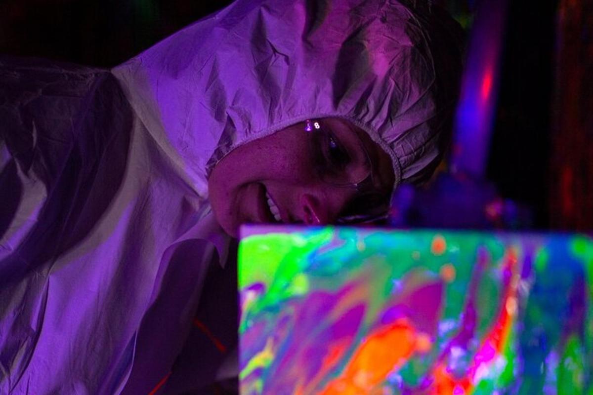 a woman in a purple dress looking at a computer screen