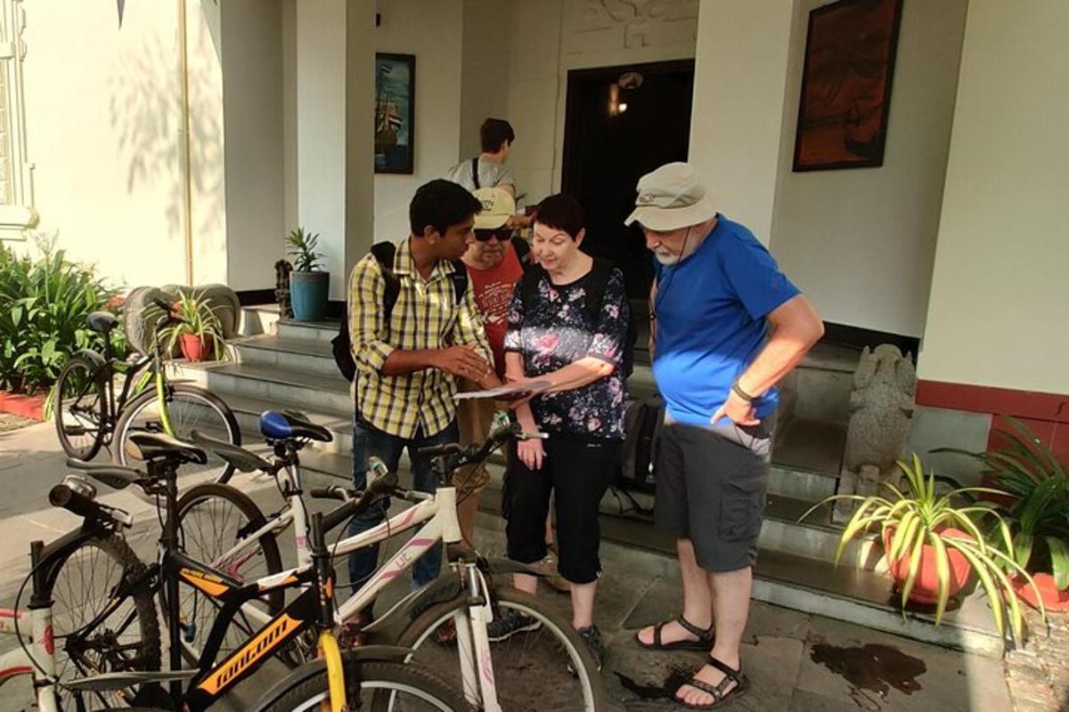 a group of people standing next to some bikes