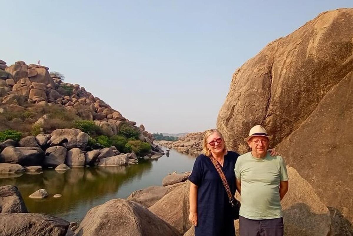 a man and a woman standing next to a river