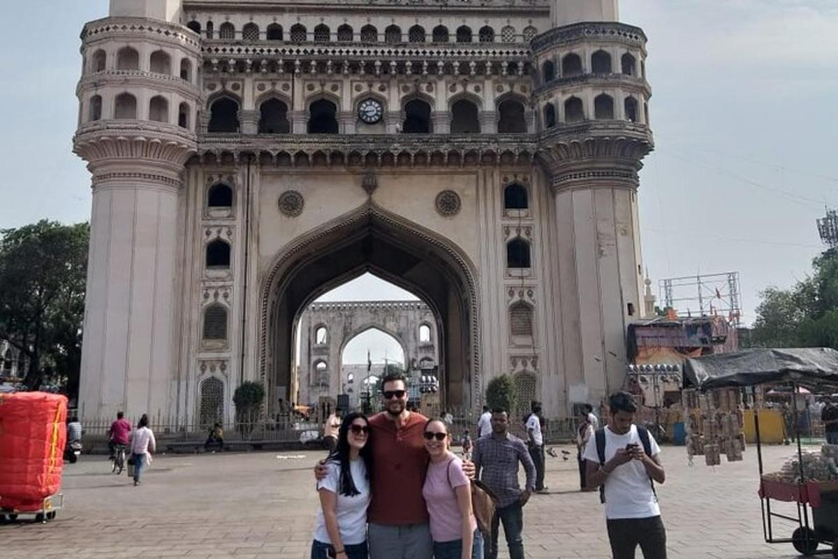 a group of people standing in front of a clock tower