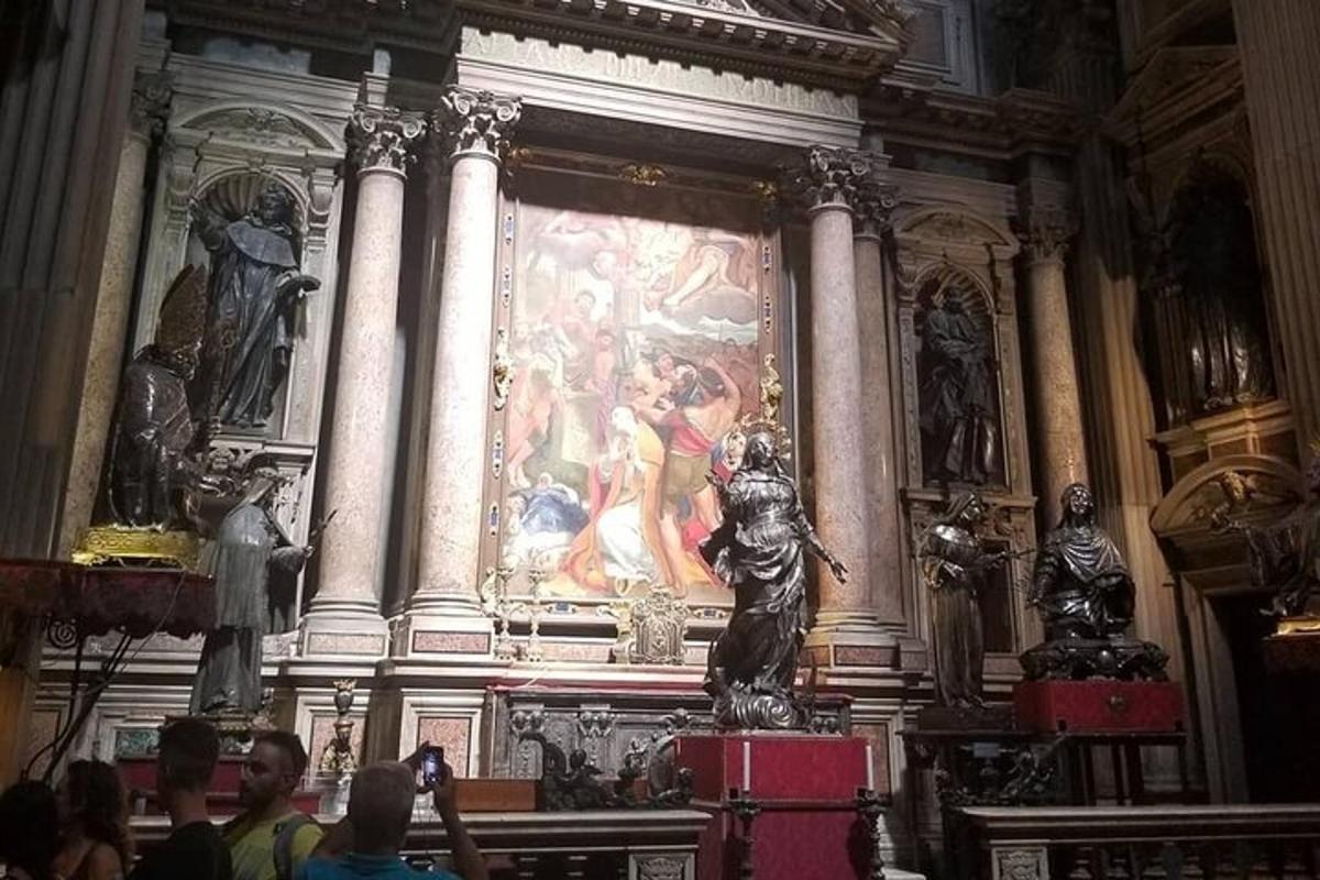 a statue in a room with a painting on the wall
