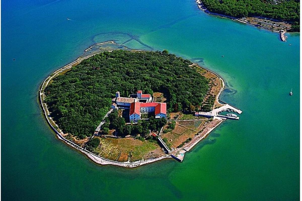 an island in the water with a building on it