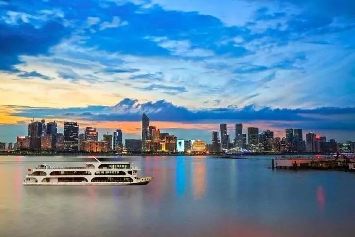 two boats in the water with a city in the background