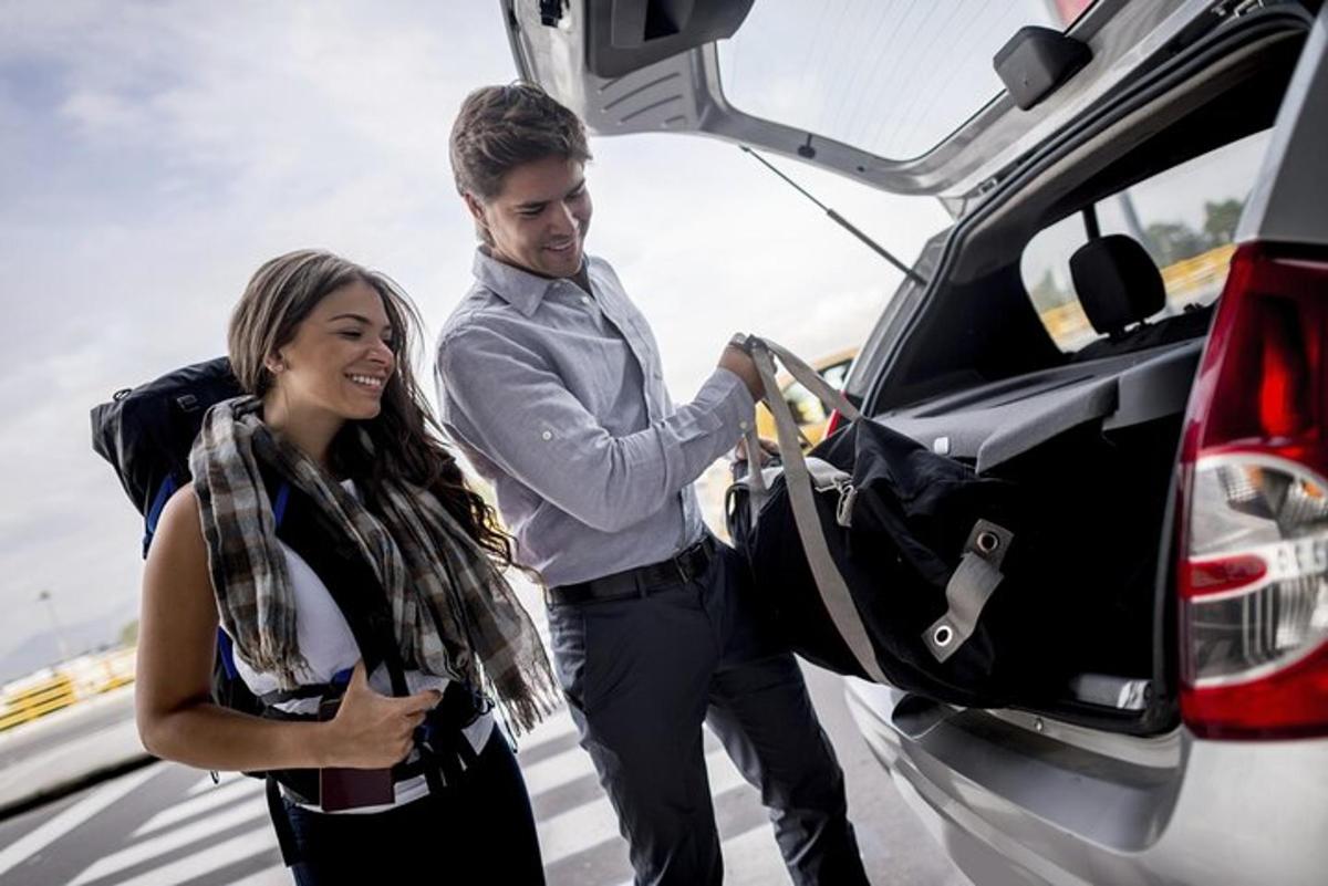 a man and a woman getting into a car