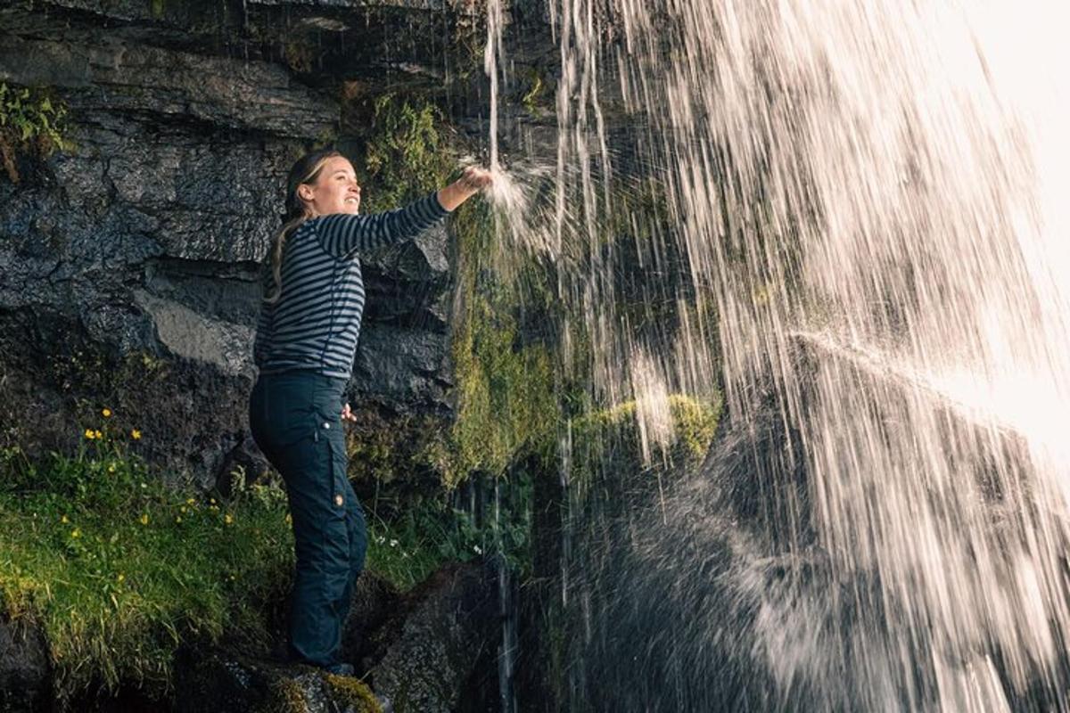 kona stendur við foss