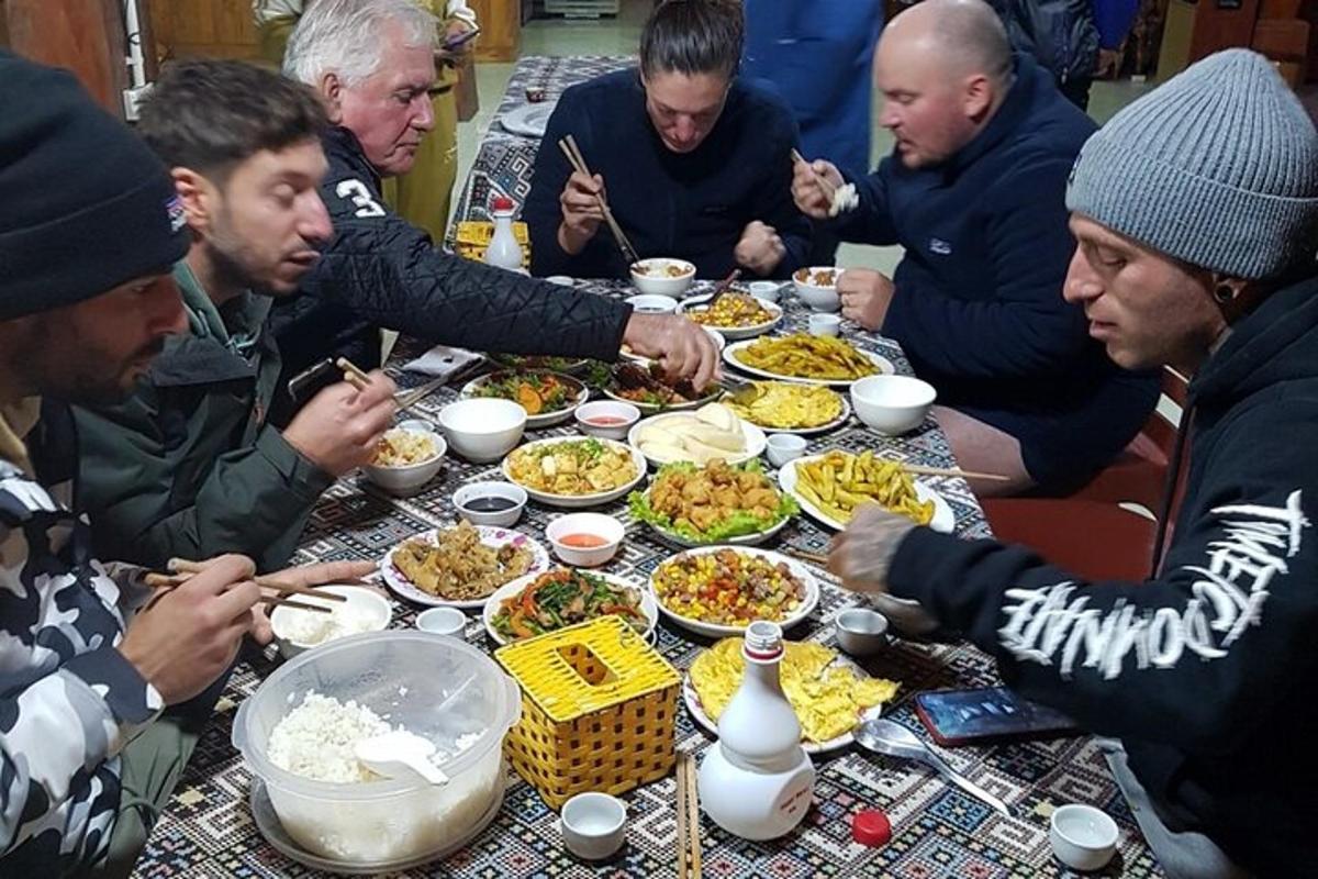 a group of people sitting around a table eating food
