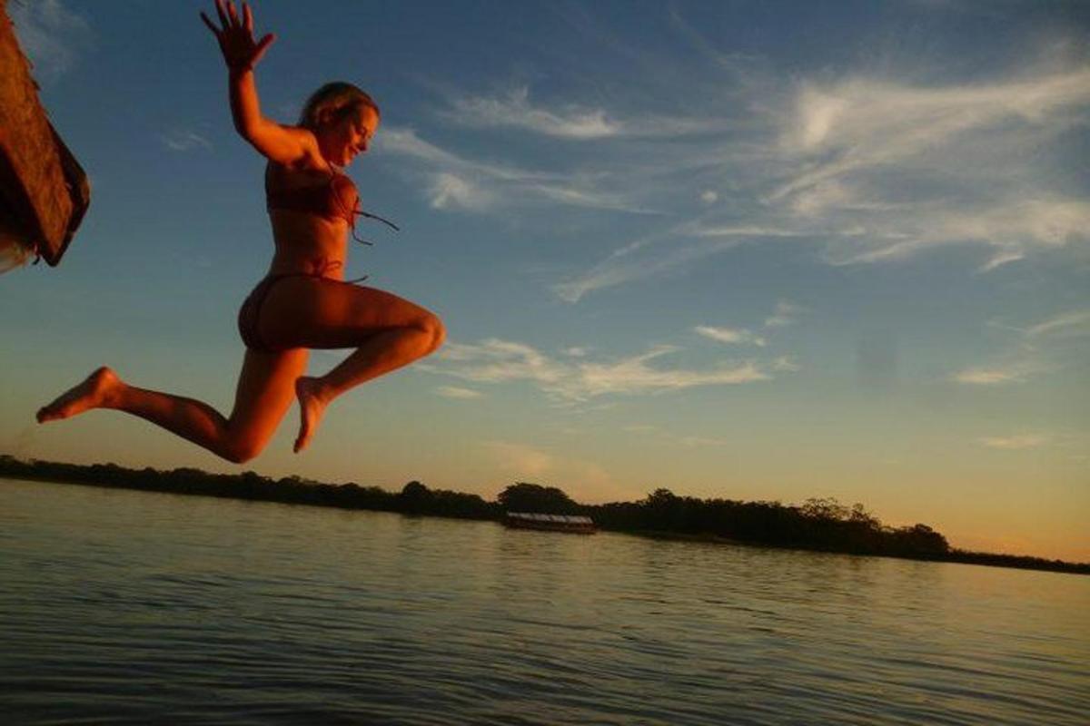 a man jumping in the air over a body of water
