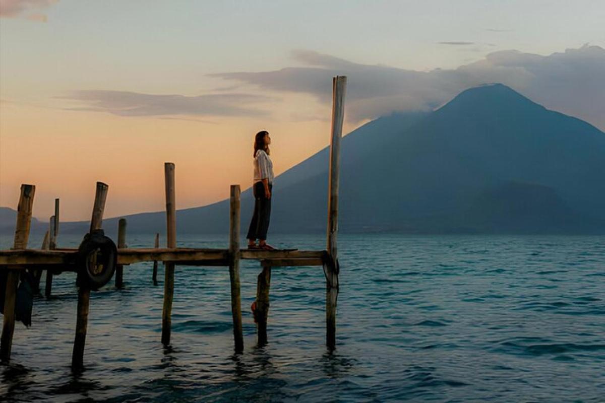 a woman standing on a dock in the water