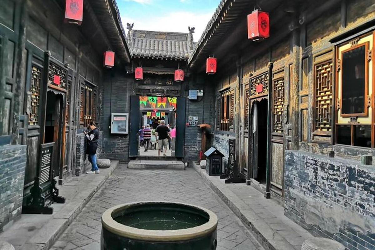 an alley in an asian building with a trash can