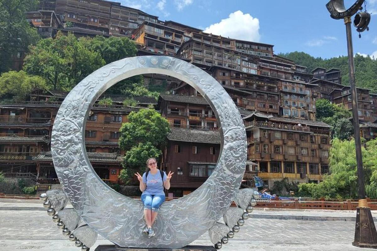 a woman is sitting inside of a metal sculpture