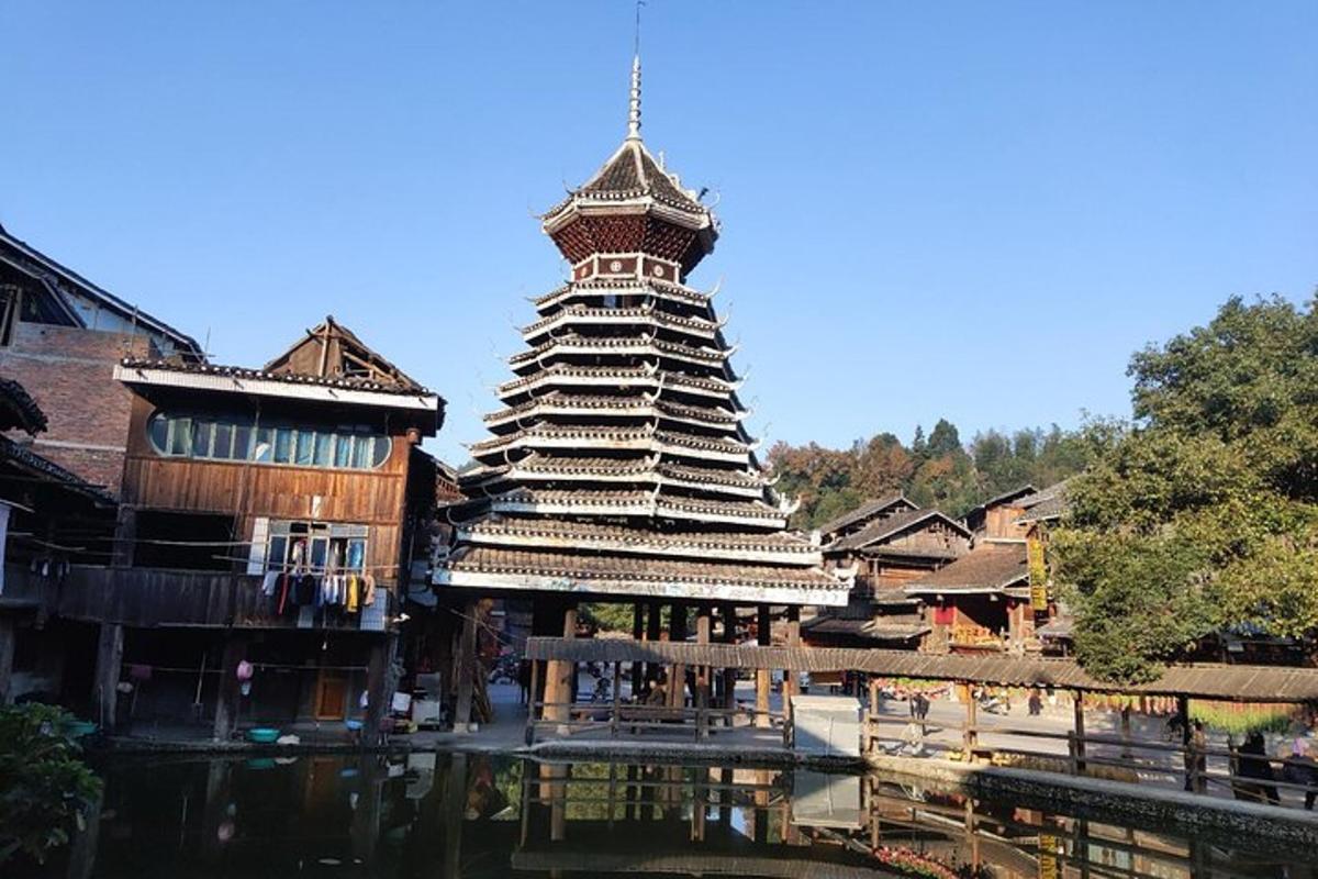 a large building with a tower next to a river