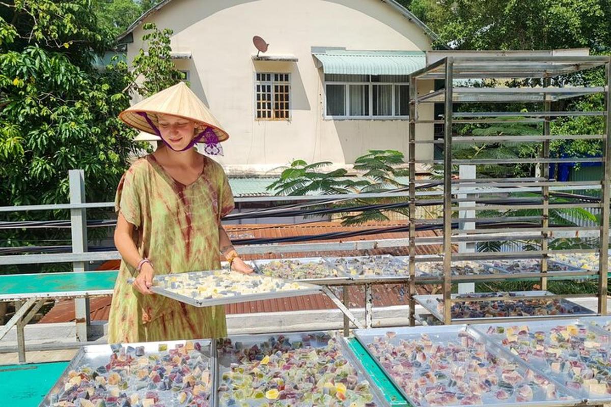 a woman wearing a hat standing next to a display of birds