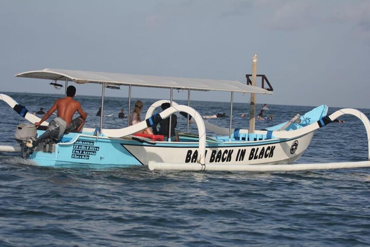 a man is sitting on a boat in the water