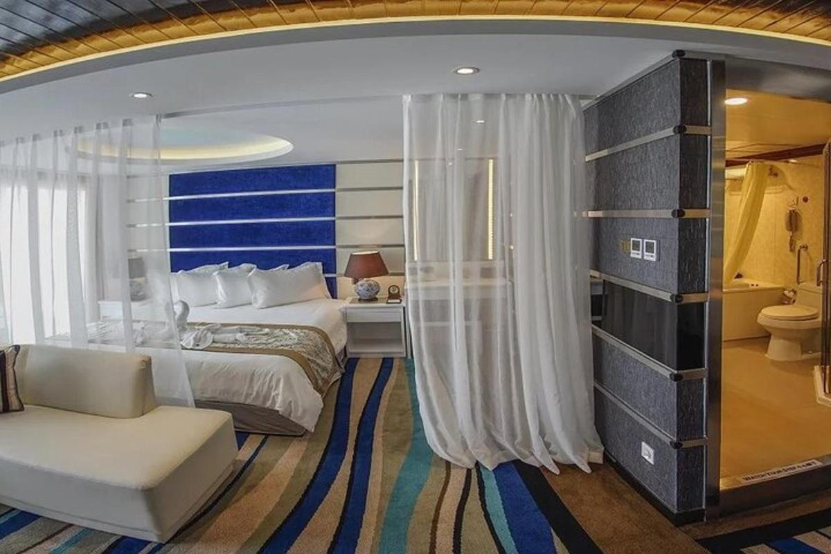 a bedroom with a bed and a couch and a chair