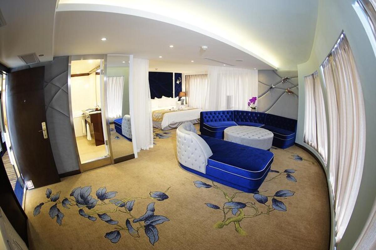 a living room with a blue couch and a bedroom