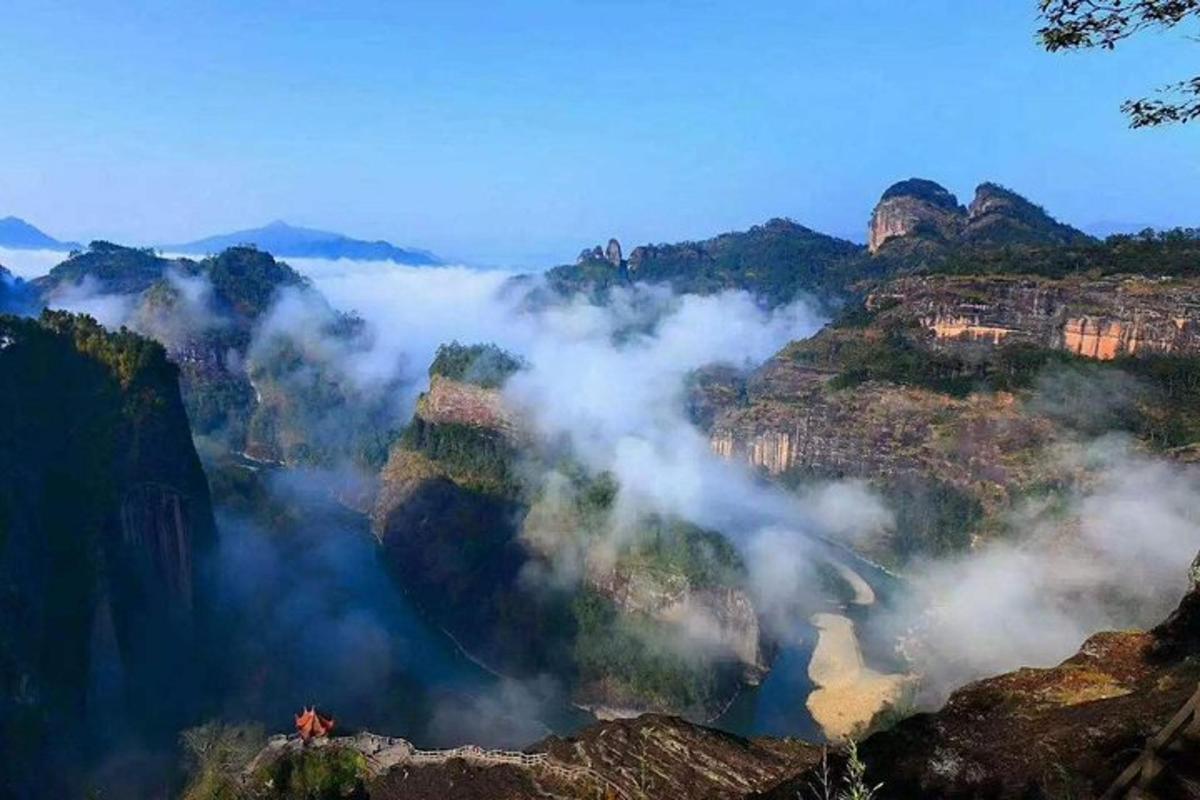 a view of a mountain covered in clouds
