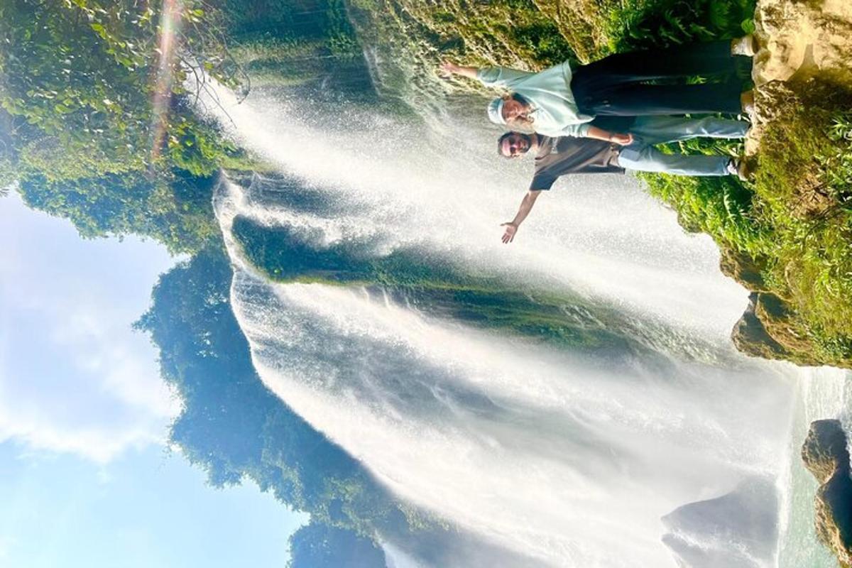 a man standing on the side of a wave in the water
