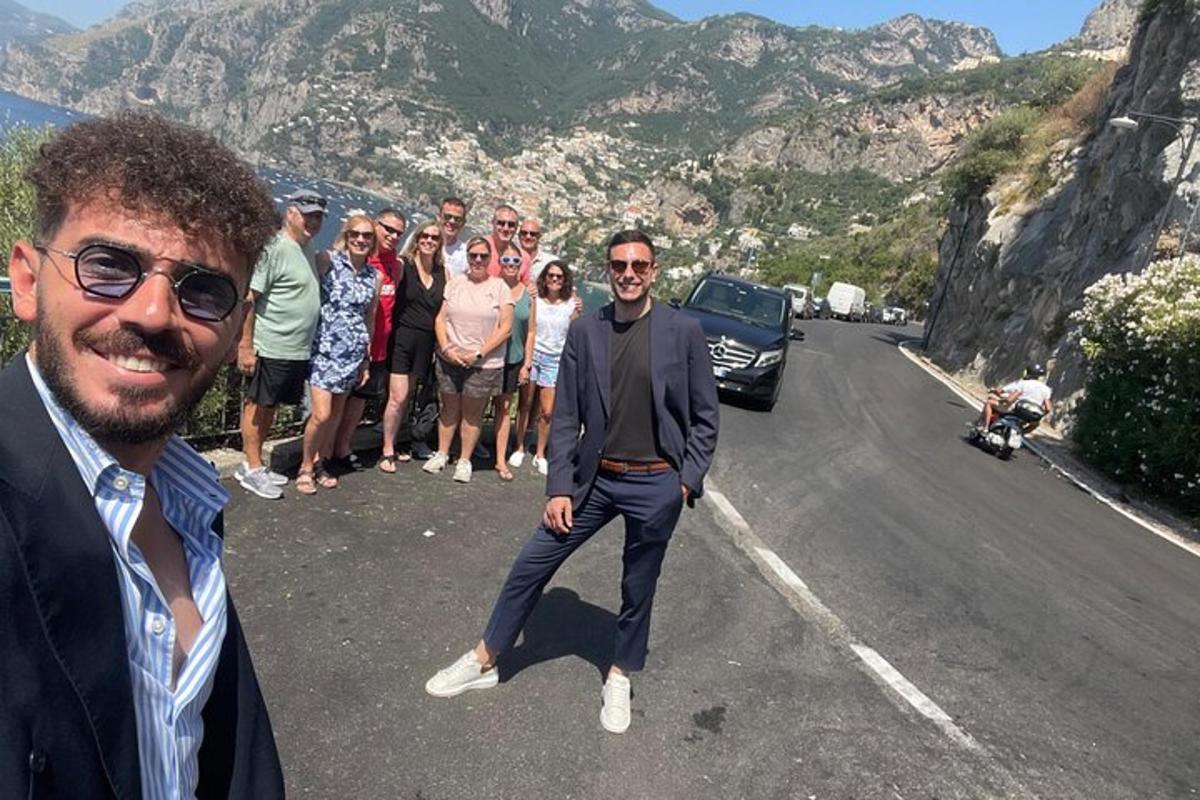 μια ομάδα ανθρώπων που στέκονται στην άκρη ενός δρόμου