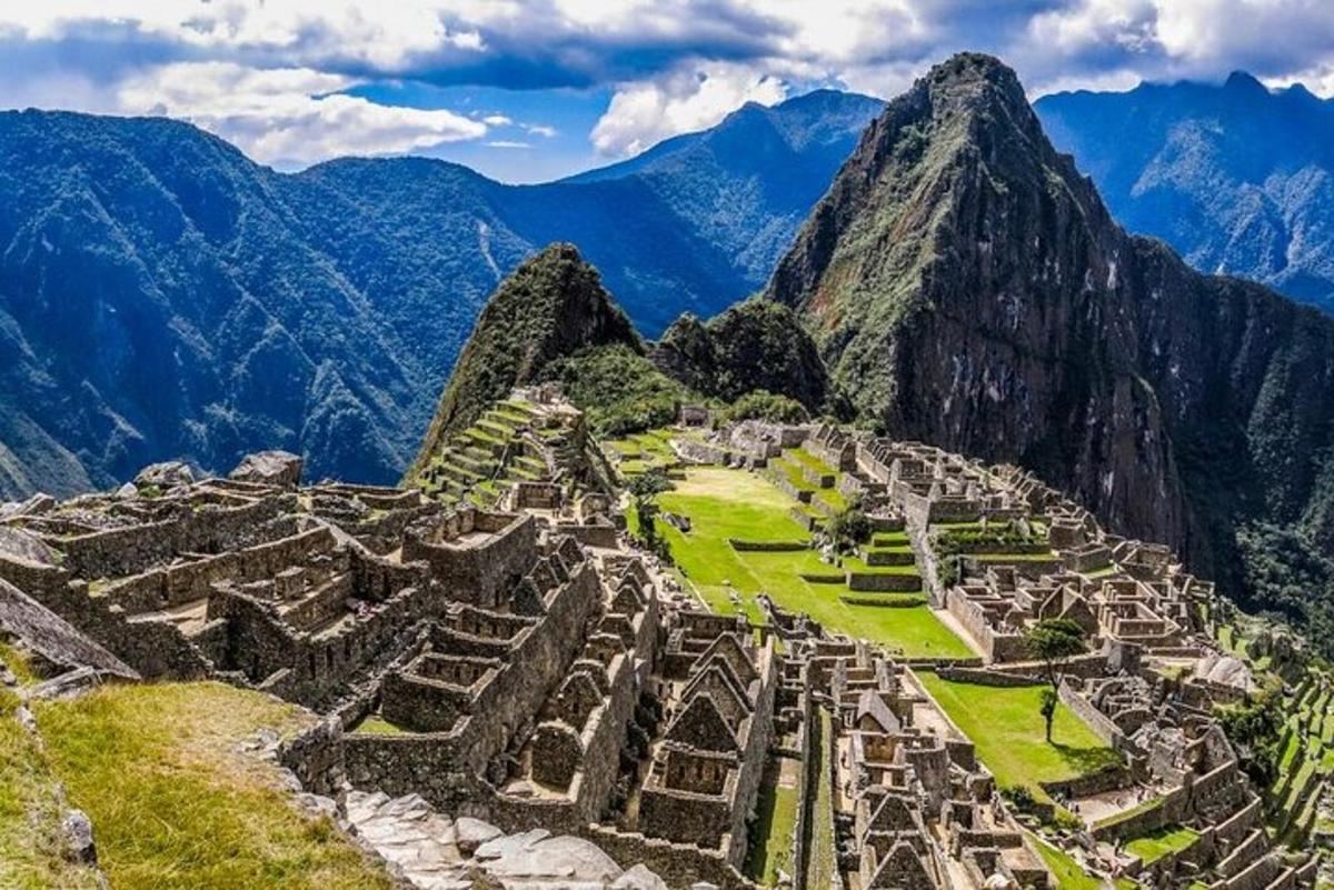 an aerial view of machu picchu with mountains in the background