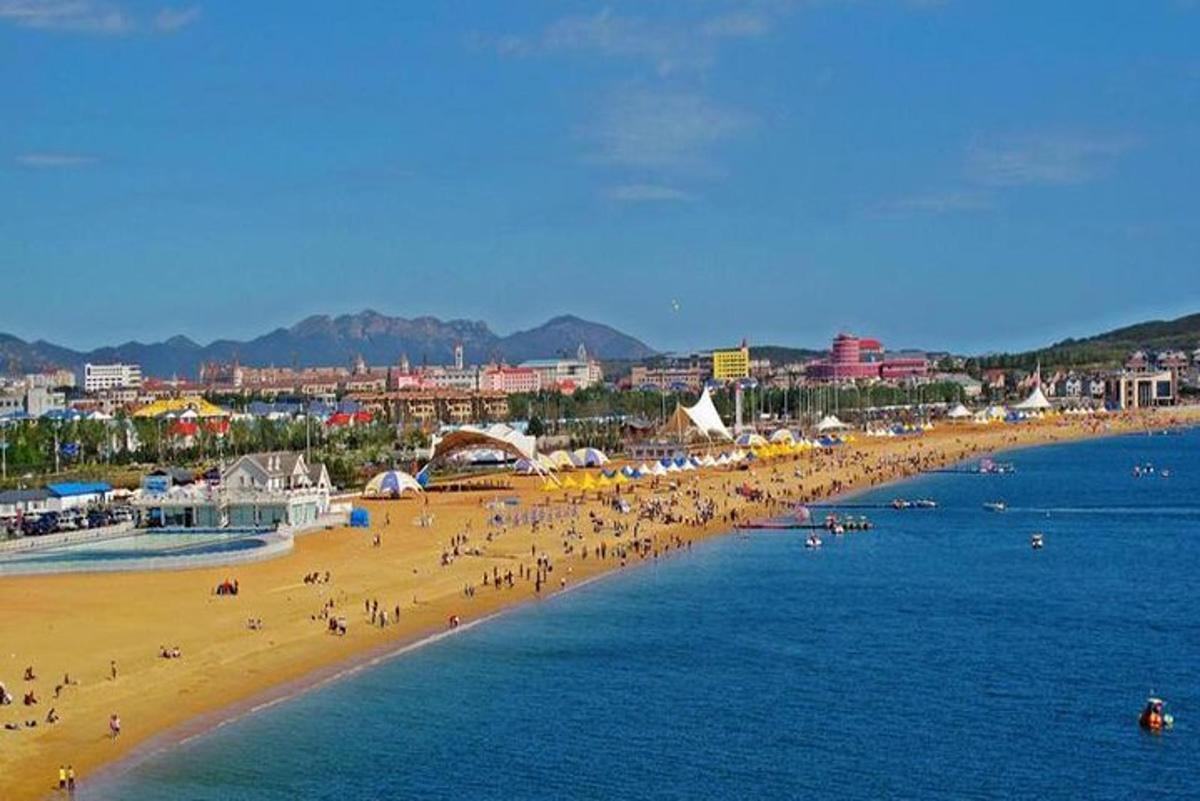 a group of people on a beach near the water